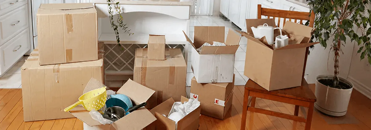 Packed moving boxes and household items in a kitchen before move-out or move-in cleaning, Jackson, MI.